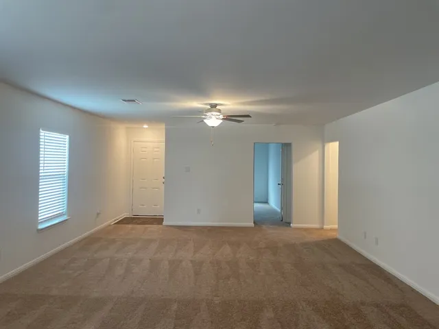 a view of an empty room with a window