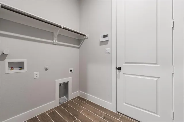 a view of a livingroom with wooden floor and cabinet
