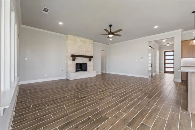 a view of empty room with wooden floor and fireplace