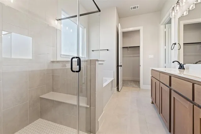 a bathroom with a shower and a sink