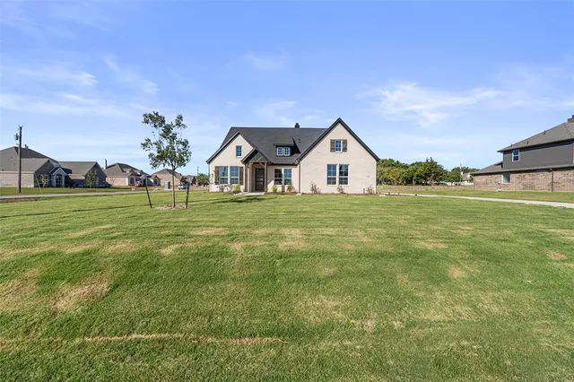 a view of a house with a big yard and potted plants