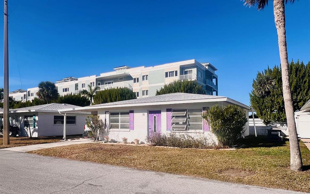 1977 Beach Road, Unit 21 Englewood, FL 34223 - Photo 18 of 27 a front view of a house with a yard