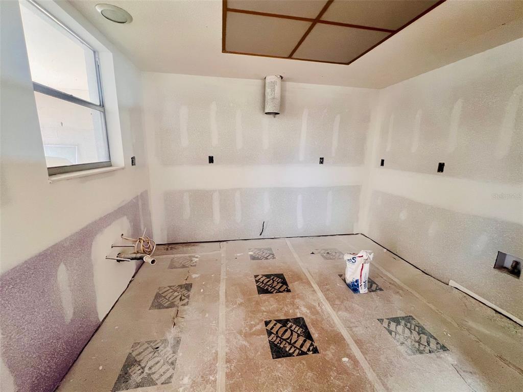 1977 Beach Road, Unit 21 Englewood, FL 34223 - Photo 7 of 27 a kitchen with a white cabinets and a stove