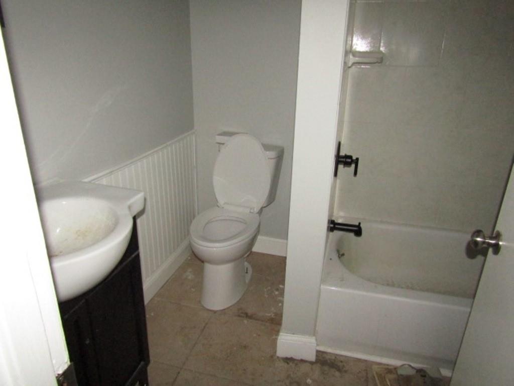 407-409 West 8th Avenue Homestead, PA 15120 - Photo 18 of 36 a white toilet sitting next to a bathtub