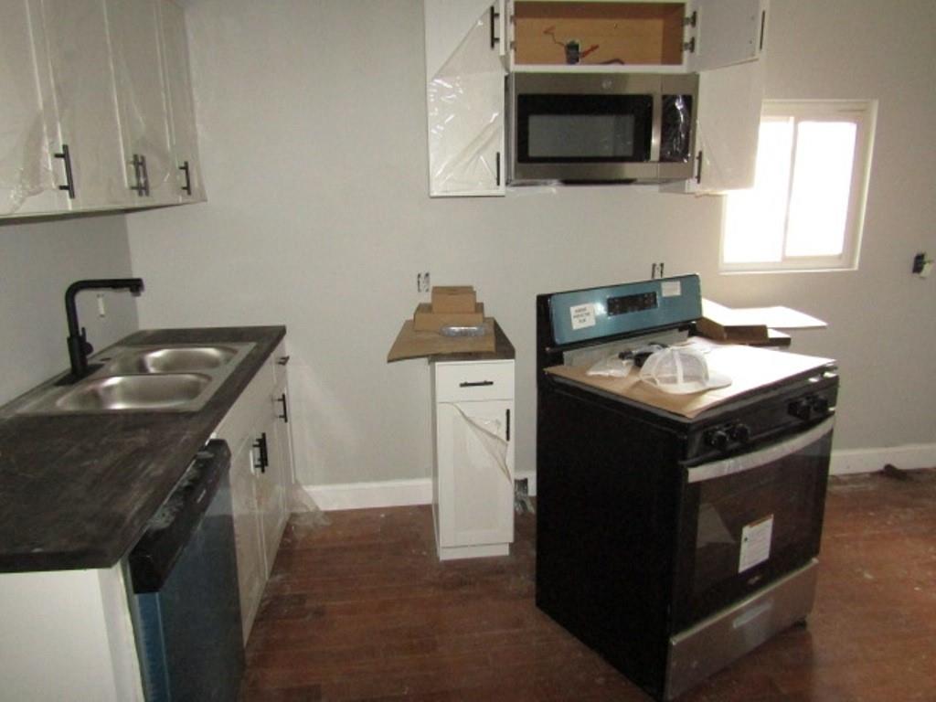 407-409 West 8th Avenue Homestead, PA 15120 - Photo 22 of 36 a kitchen with stainless steel appliances granite countertop a stove a sink and a microwave