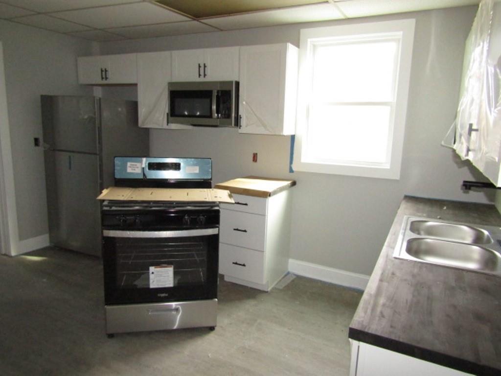 407-409 West 8th Avenue Homestead, PA 15120 - Photo 30 of 36 a kitchen with a stove and a microwave