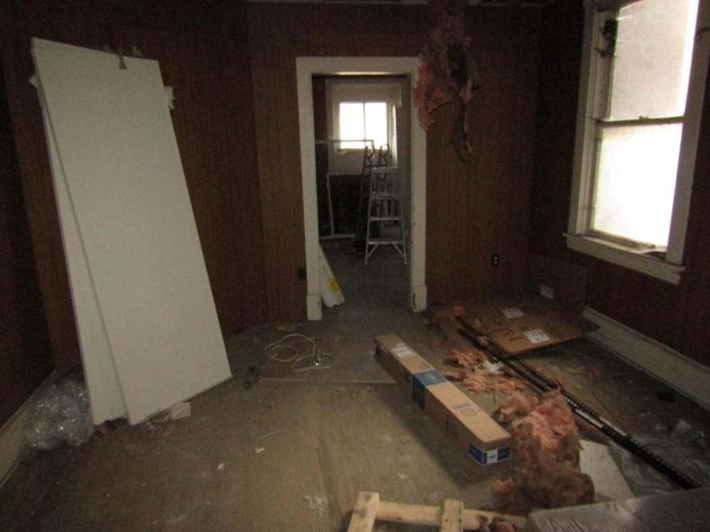 407-409 West 8th Avenue Homestead, PA 15120 - Photo 35 of 36 a room with water heater and wooden door