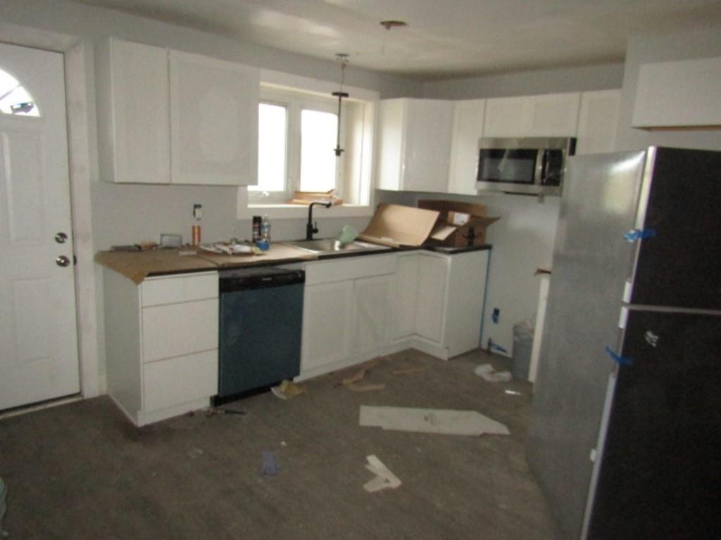 407-409 West 8th Avenue Homestead, PA 15120 - Photo 7 of 36 a kitchen with a sink stove and refrigerator