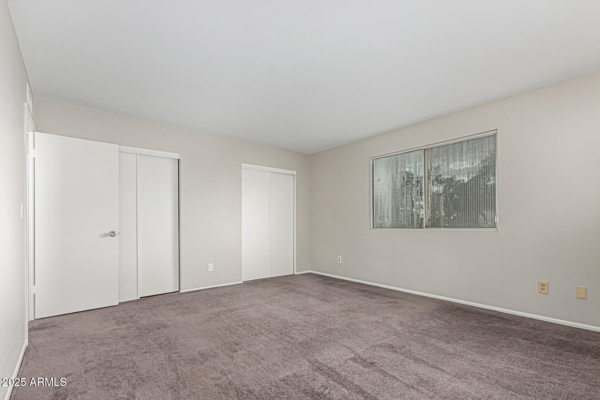 2133 West Turney Avenue, Unit D76 Phoenix, AZ 85015 - Photo 16 of 28 a view of an empty room with a window