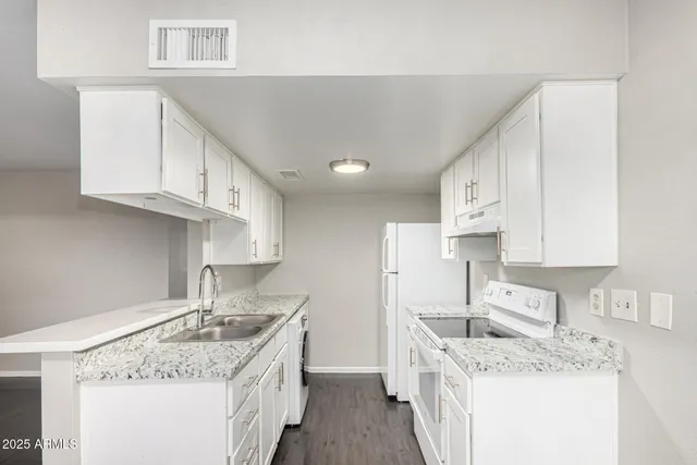a kitchen with a sink stove and cabinets