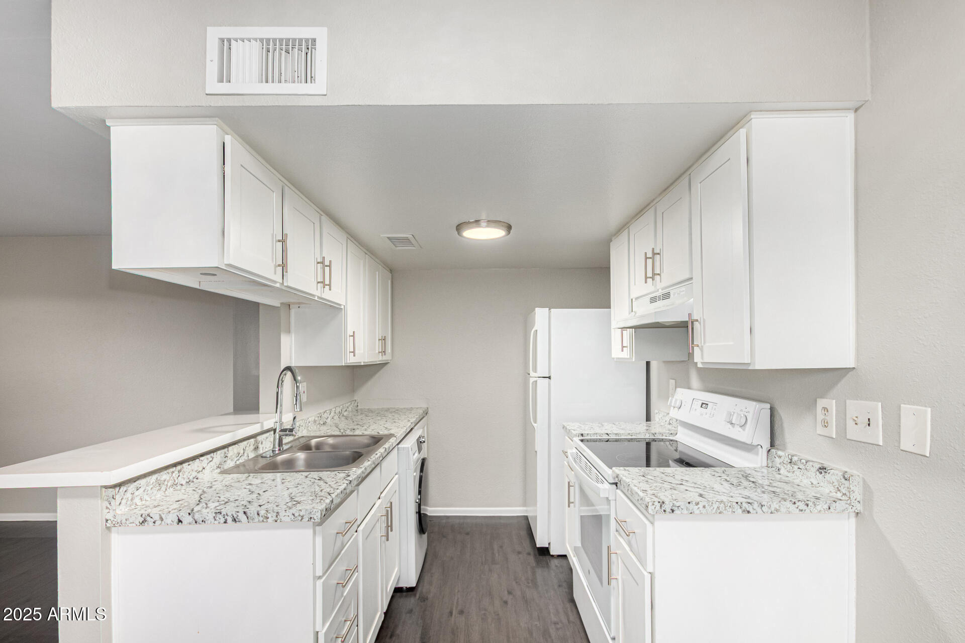 2133 West Turney Avenue, Unit D76 Phoenix, AZ 85015 - Photo 2 of 28 a kitchen with a sink stove and cabinets