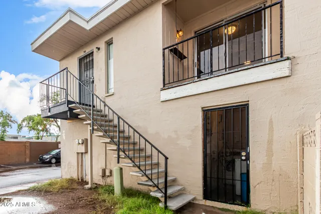 a view of staircase with railing and a window