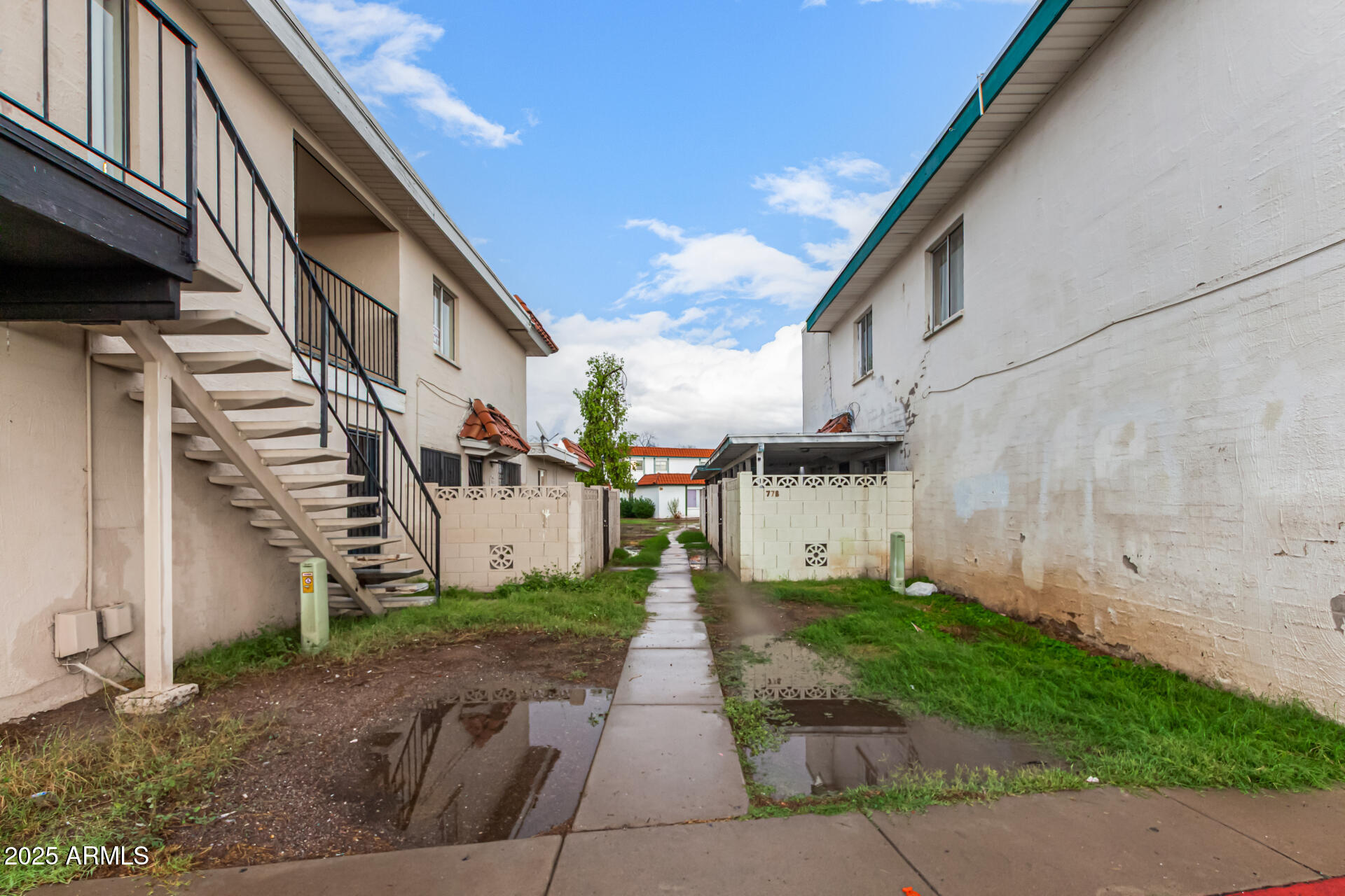 2133 West Turney Avenue, Unit D76 Phoenix, AZ 85015 - Photo 28 of 28 a view of a white house with a small yard