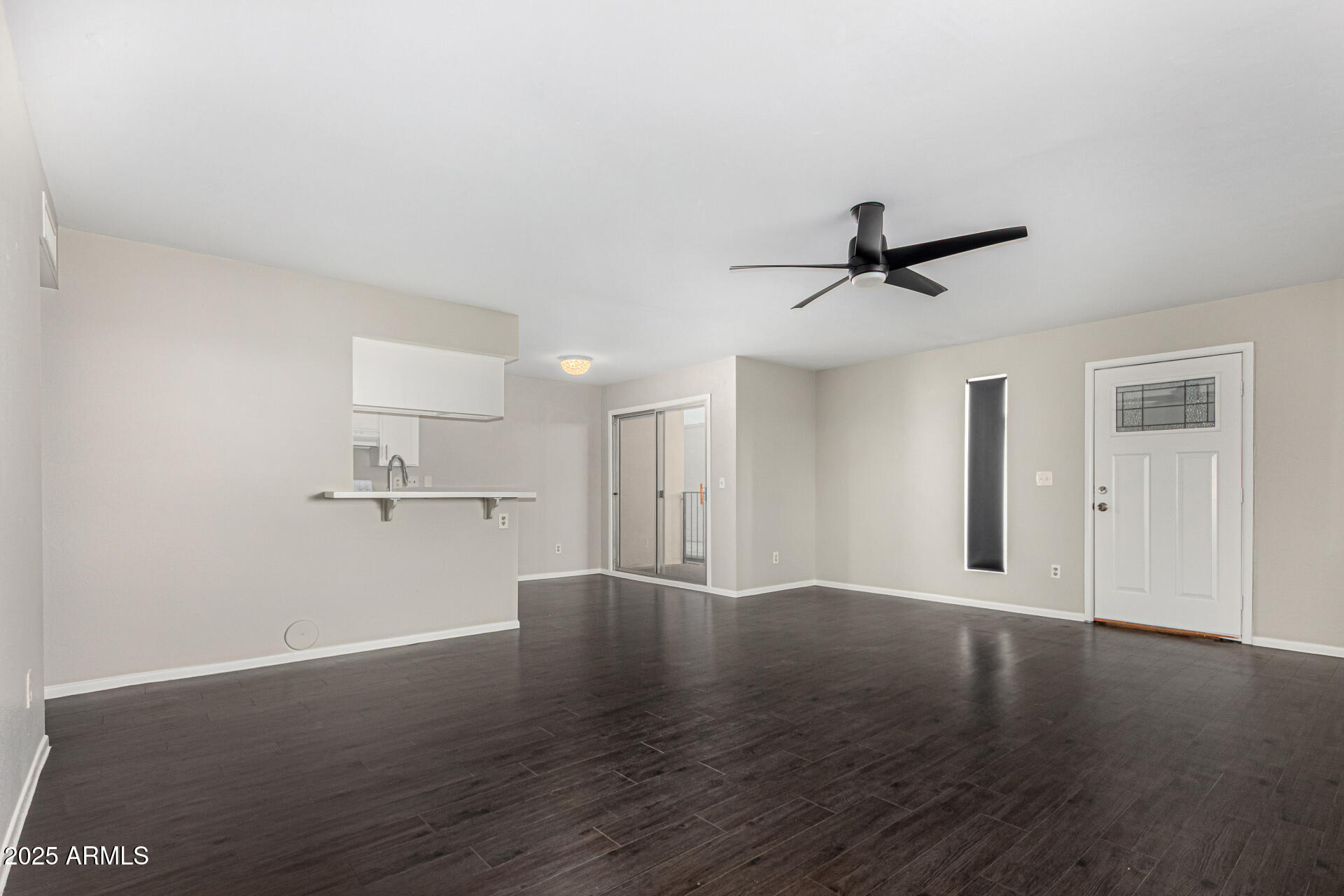 2133 West Turney Avenue, Unit D76 Phoenix, AZ 85015 - Photo 4 of 28 a view of a livingroom with wooden floor and a ceiling fan