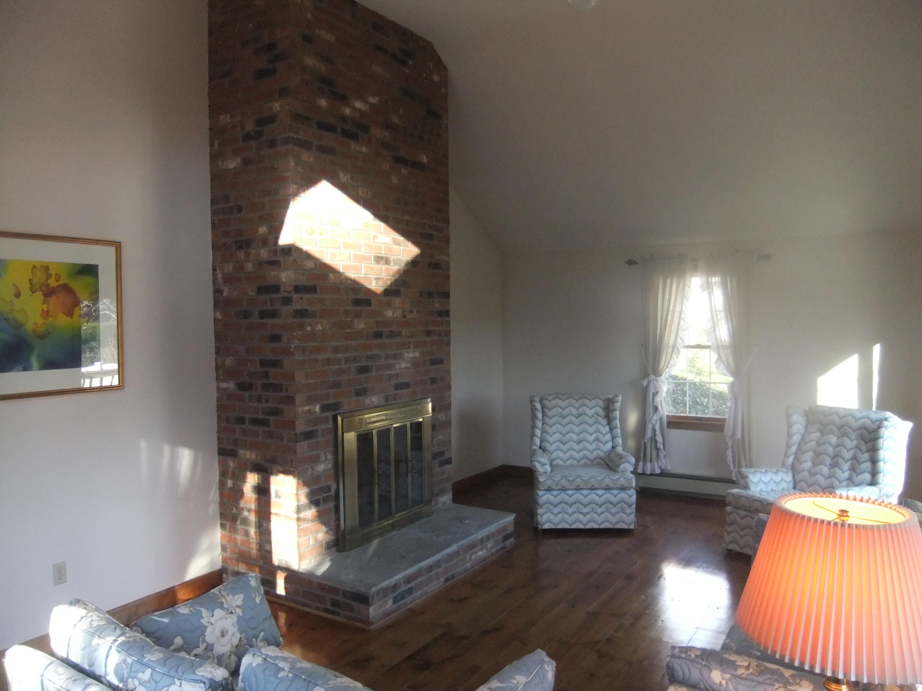 33 Ridgewood Road Orleans, MA 02653 - Photo 15 of 35 a living room with furniture and a fireplace