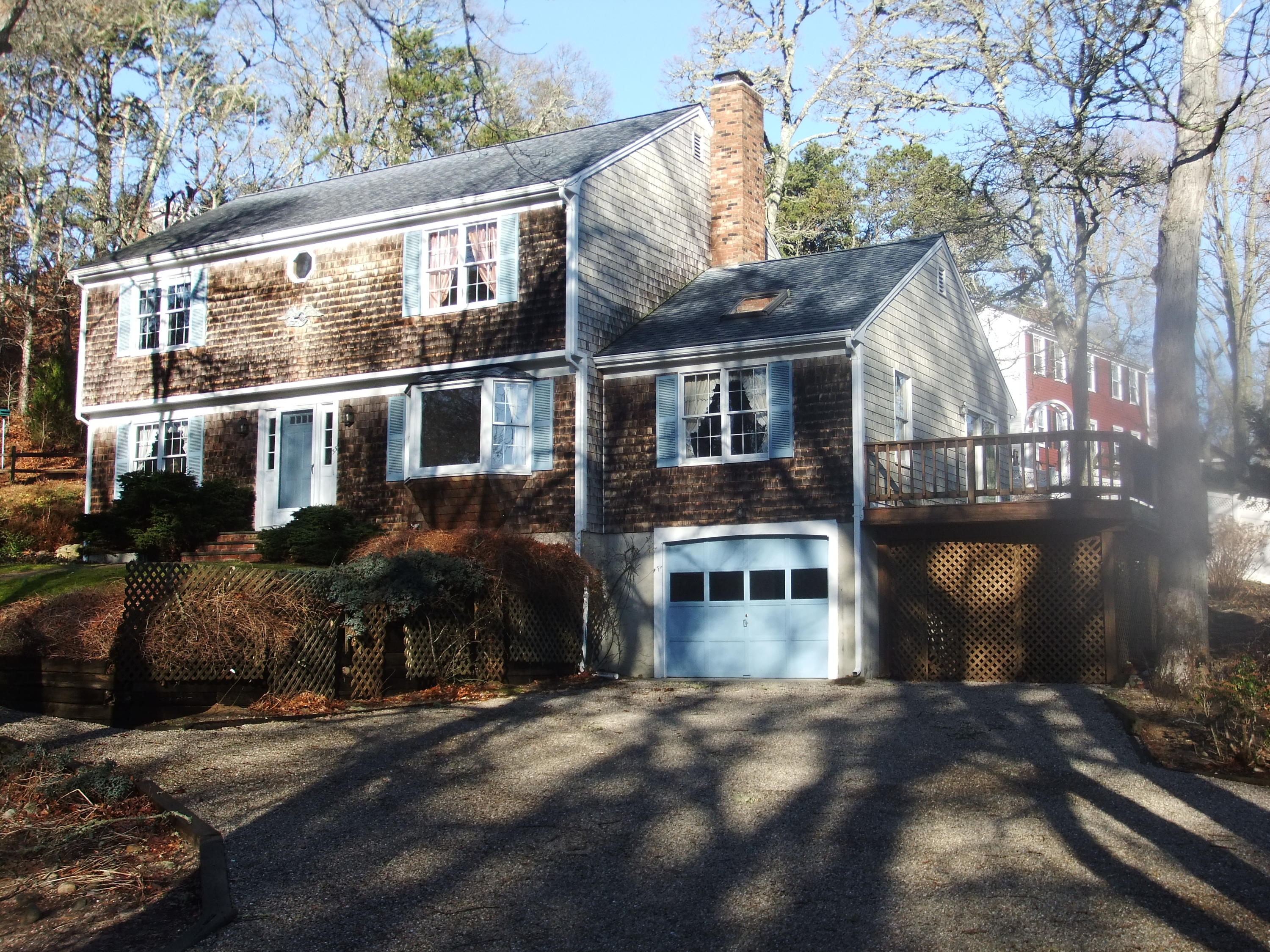 33 Ridgewood Road Orleans, MA 02653 - Photo 2 of 35 a front view of a house with a yard and garage