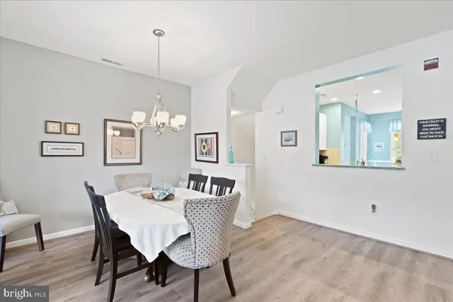 a living room with furniture wooden floor and a large window