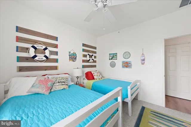 a living room with baby crib furniture and a window