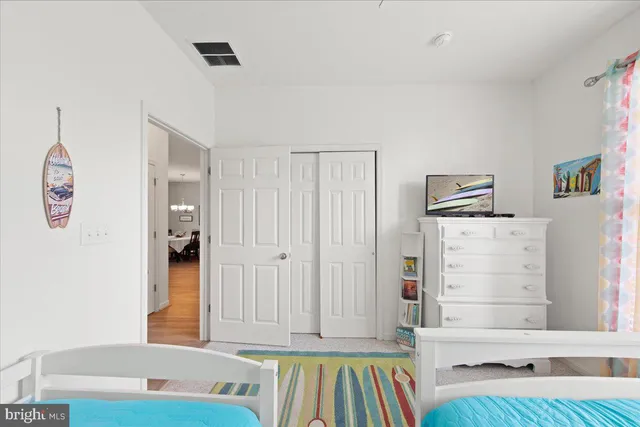 a bedroom with furniture and wooden floor