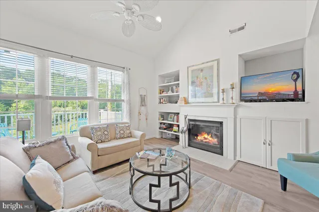 a living room with furniture fireplace and window