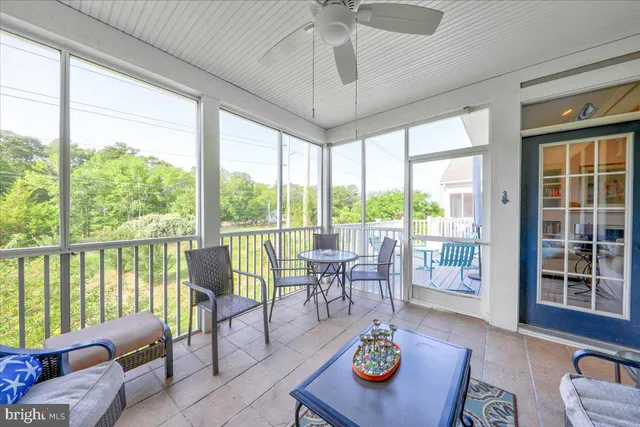 a living room with furniture and floor to ceiling windows