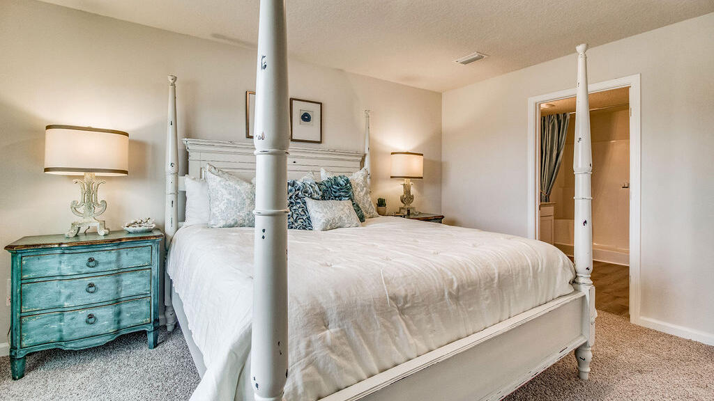 3431 Phoenix Court Crestview, FL 32539 - Photo 9 of 29 a bedroom with a bed and a lamp on dresser