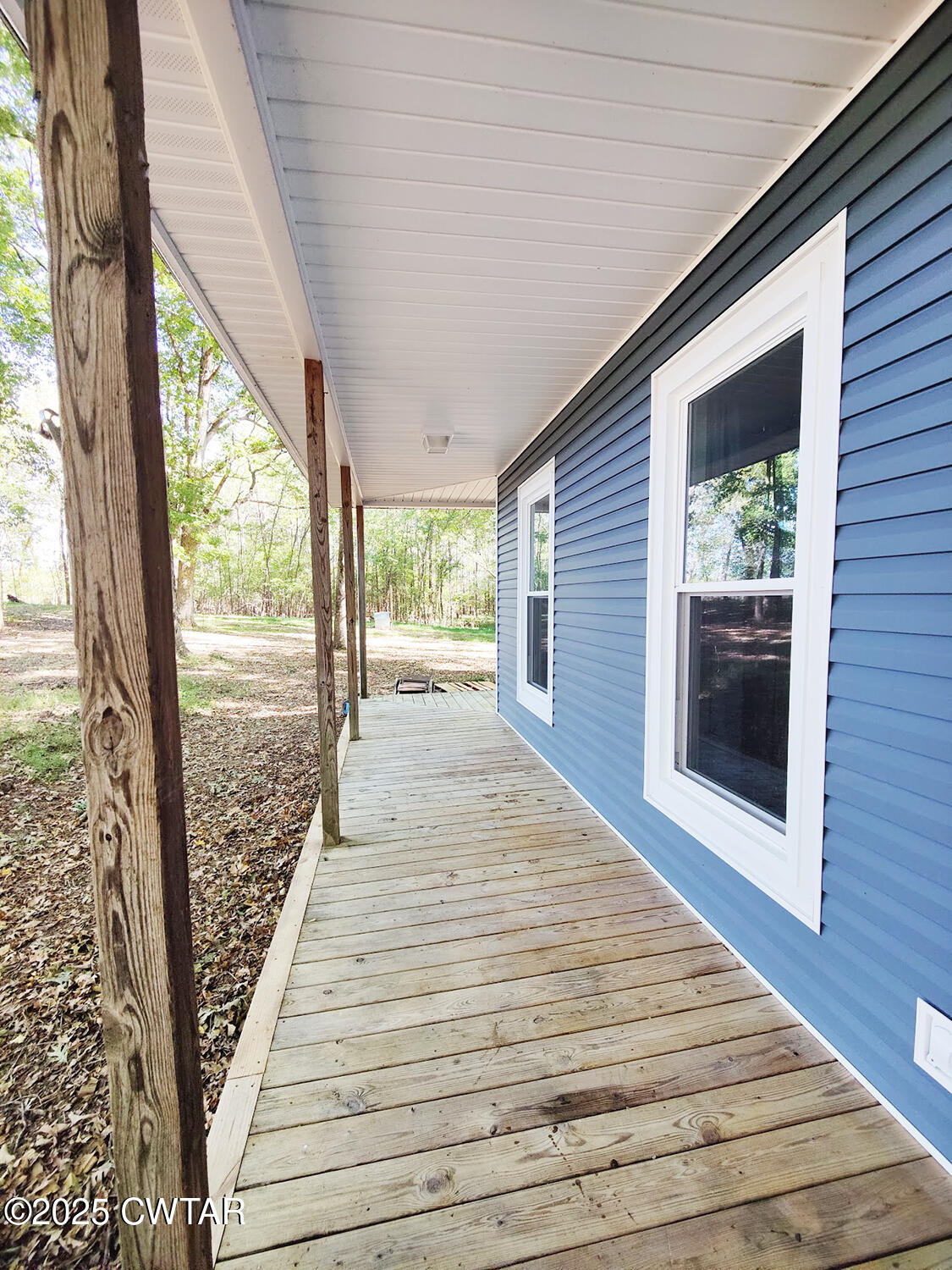 1620 Brooks Road Atwood, TN 38220 - Photo 7 of 34 a view of a balcony with wooden floor and floor to ceiling window
