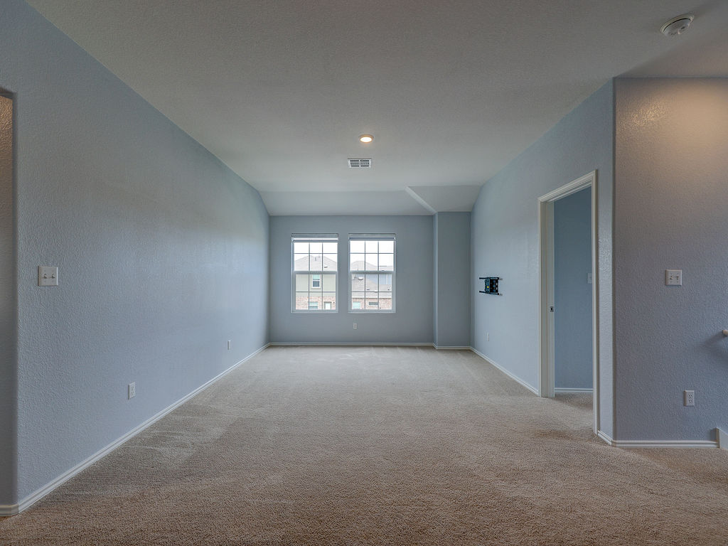 1716 Frontenac Street Leander, TX 78641 - Photo 30 of 34 a view of a big room with windows and chandelier fan