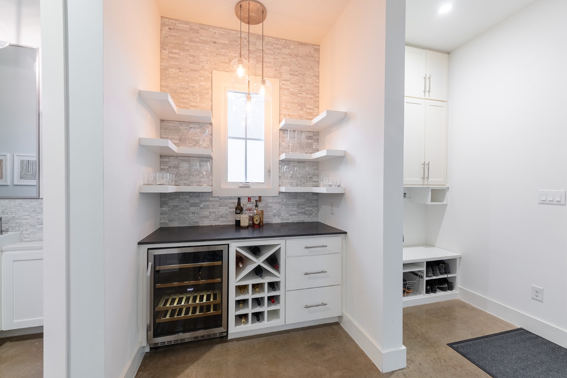 712 Cardinal Lane, Unit A Austin, TX 78704 - Photo 16 of 37 Last owners also added fun and functional dry bar with beverage fridge, wine storage, and decorative tile.