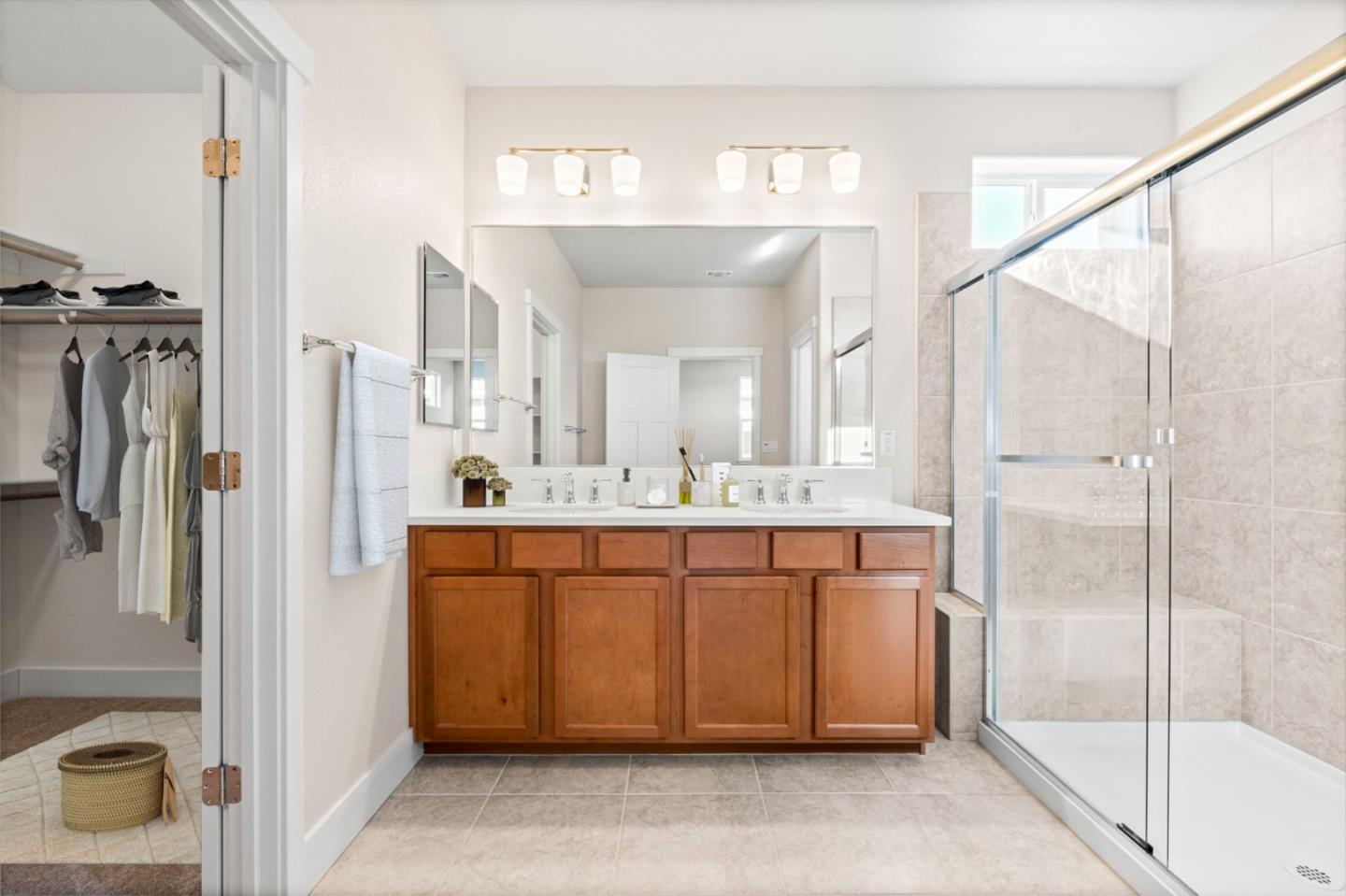 19134 Fallingwater Lane Marina, CA 93933 - Photo 17 of 32 a bathroom with a sink a mirror and a shower