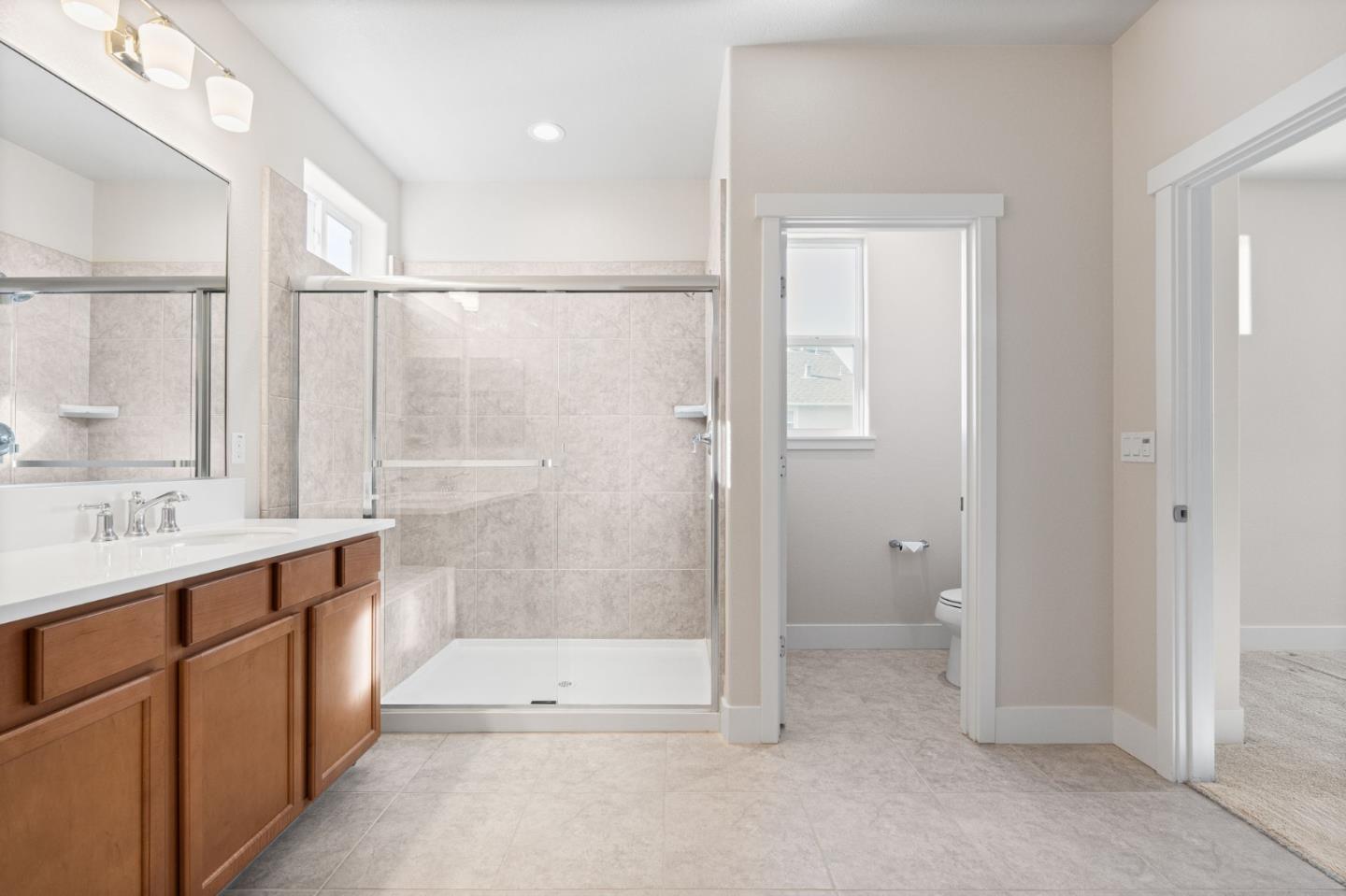 19134 Fallingwater Lane Marina, CA 93933 - Photo 20 of 32 a bathroom with a shower sink and mirror