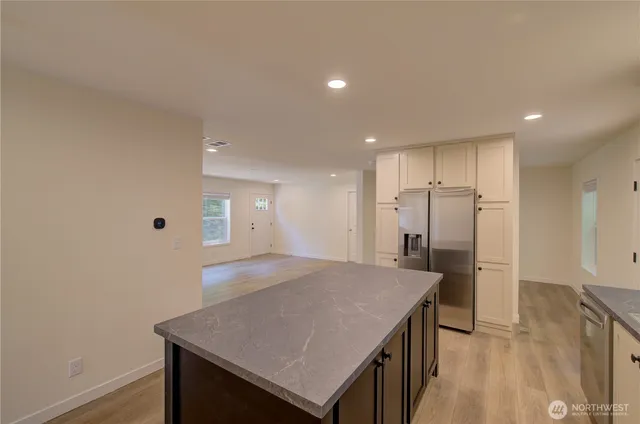 a kitchen with a wooden floor and window