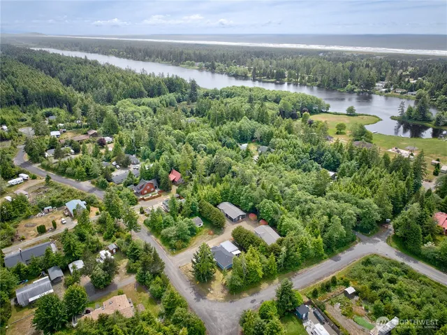 a view of a house with a backyard and a tree