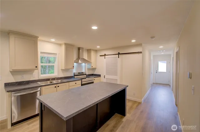 a kitchen with a stove a sink and a refrigerator