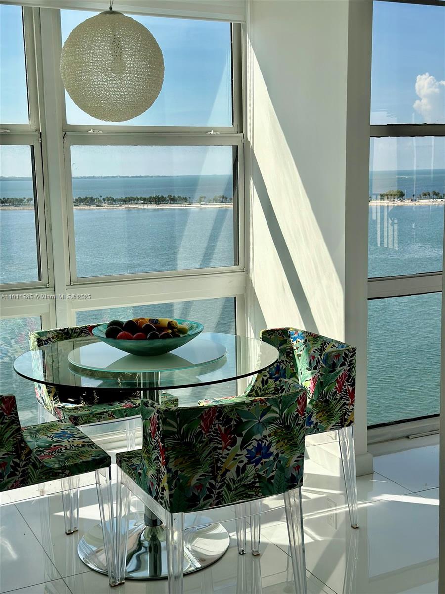1865 Brickell Avenue, Unit A1209 Miami, FL 33129 - Photo 18 of 26 a dining room with wooden floor