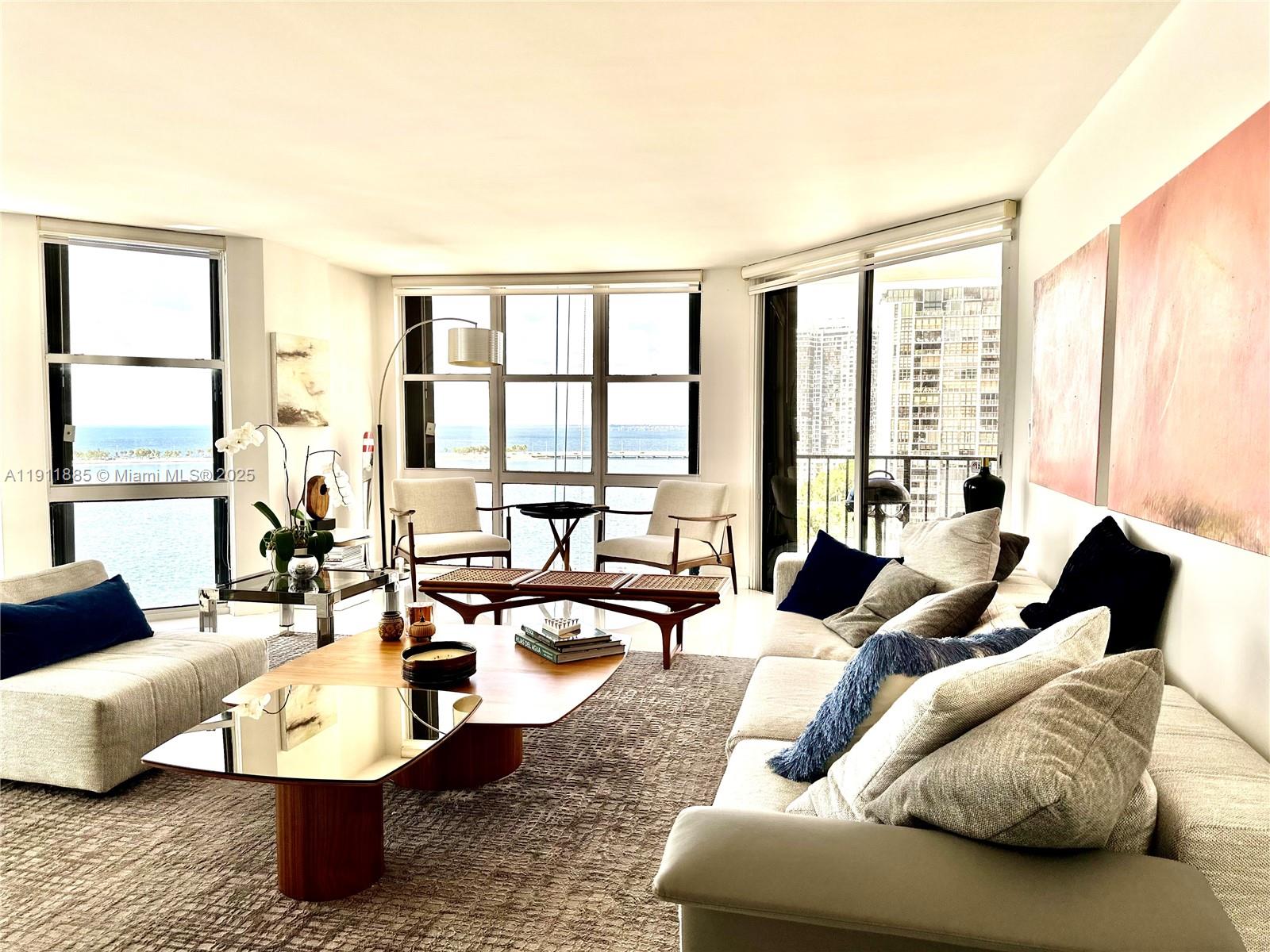 1865 Brickell Avenue, Unit A1209 Miami, FL 33129 - Photo 20 of 26 a living room with furniture and large windows