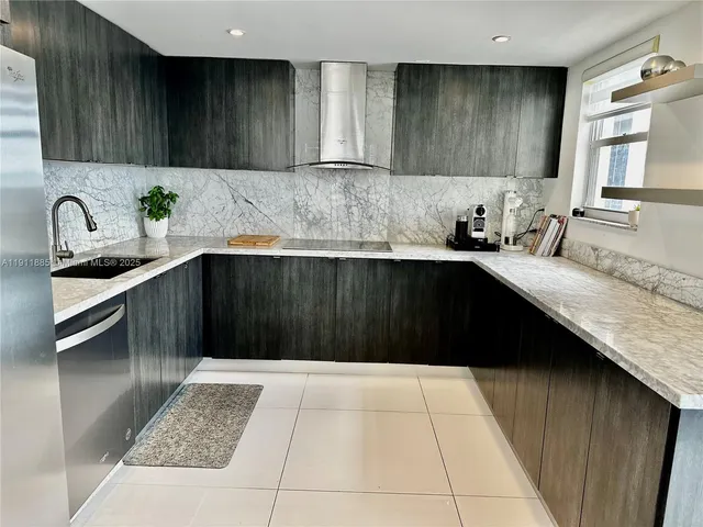 a kitchen with granite countertop a sink and cabinets