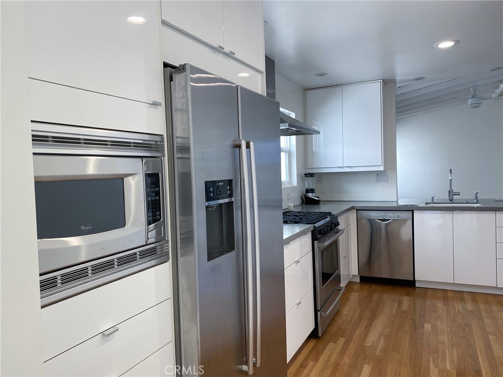 656 Rosecrans Avenue Manhattan Beach, CA 90266 - Photo 11 of 32 a kitchen with stainless steel appliances and wooden cabinets