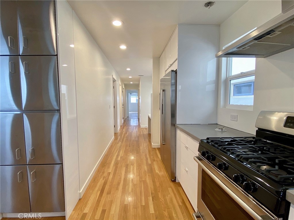 656 Rosecrans Avenue Manhattan Beach, CA 90266 - Photo 12 of 32 a kitchen with stainless steel appliances granite countertop a refrigerator and a stove top oven