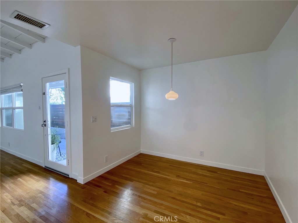 656 Rosecrans Avenue Manhattan Beach, CA 90266 - Photo 13 of 32 a view of an empty room with wooden floor and a window