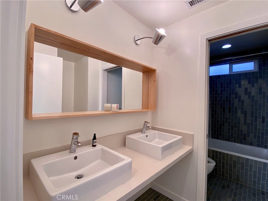 656 Rosecrans Avenue Manhattan Beach, CA 90266 - Photo 17 of 32 a bathroom with 2 sink and a mirror