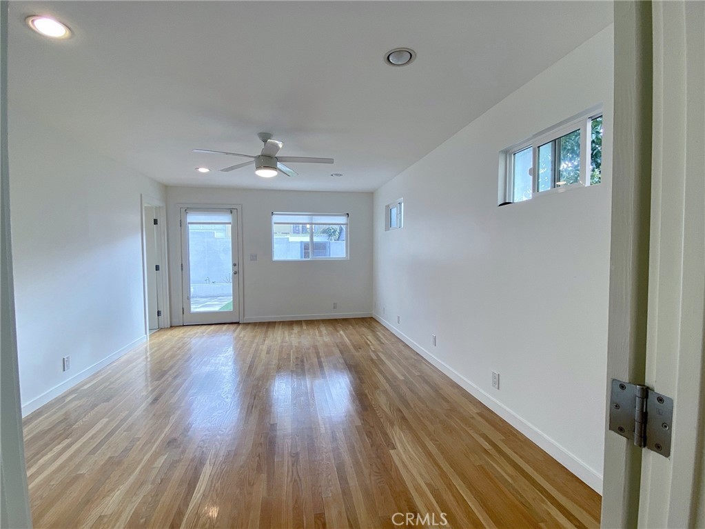 656 Rosecrans Avenue Manhattan Beach, CA 90266 - Photo 22 of 32 a view of an empty room with wooden floor and a window
