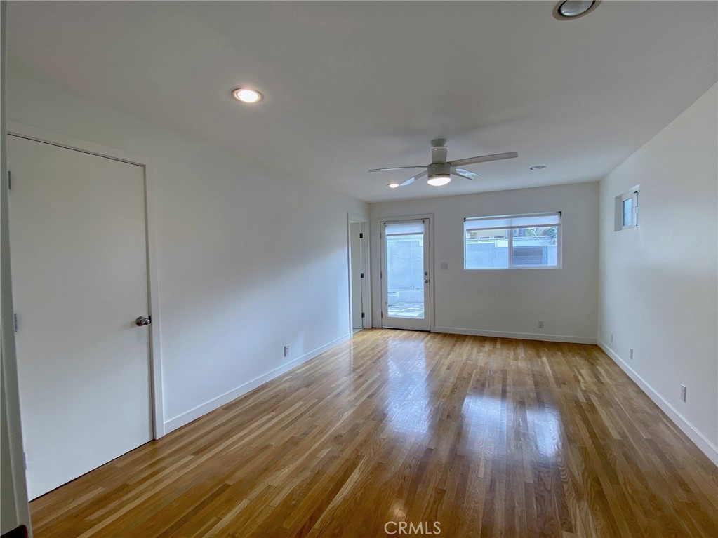 656 Rosecrans Avenue Manhattan Beach, CA 90266 - Photo 23 of 32 a view of an empty room with wooden floor and a window