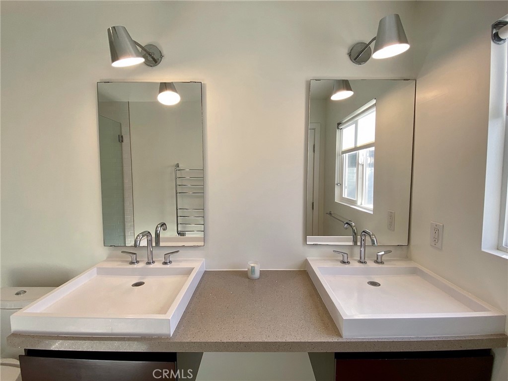656 Rosecrans Avenue Manhattan Beach, CA 90266 - Photo 27 of 32 a bathroom with a double vanity sink and a mirror