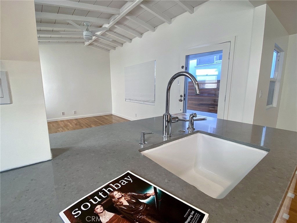 656 Rosecrans Avenue Manhattan Beach, CA 90266 - Photo 10 of 32 a kitchen with a sink and a stove top oven