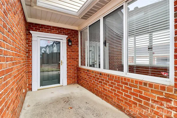 a view of a brick house with a large window