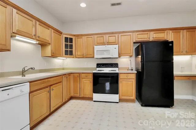 a kitchen with a refrigerator stove and sink