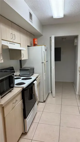 a kitchen with a stove and a refrigerator