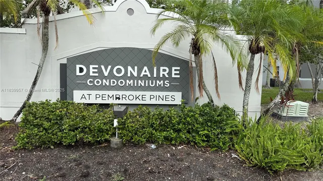 a sign broad in front of red brick house