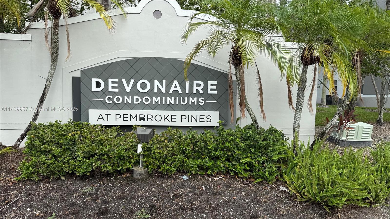 11133 Southwest 8th Street, Unit 102 Pembroke Pines, FL 33025 - Photo 18 of 35 a sign broad in front of red brick house